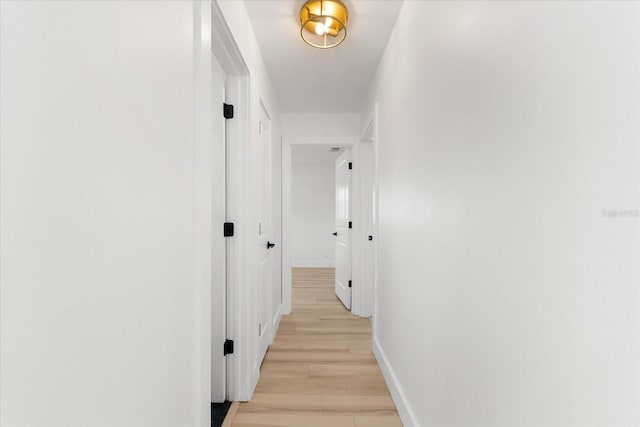 hallway with light wood-type flooring