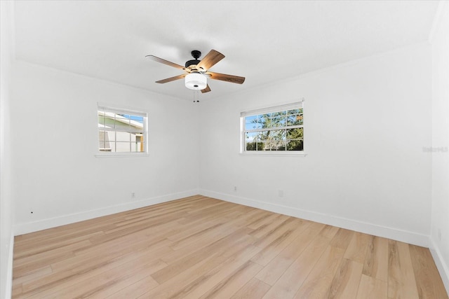 empty room with light hardwood / wood-style flooring, ceiling fan, and a healthy amount of sunlight