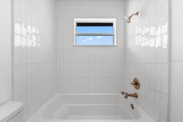 bathroom featuring bathing tub / shower combination and toilet