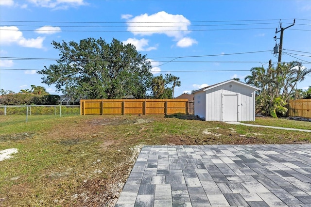 view of yard with a shed and a patio area