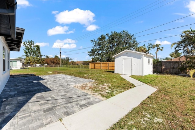 view of yard featuring a patio and a shed