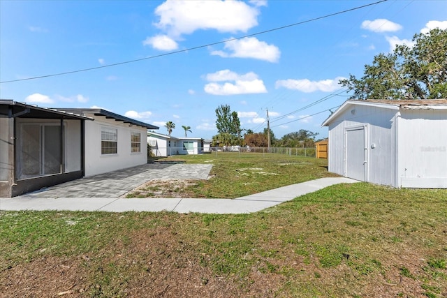 view of yard with a patio and a shed