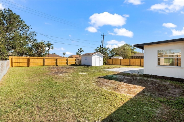 view of yard with a shed and a patio area