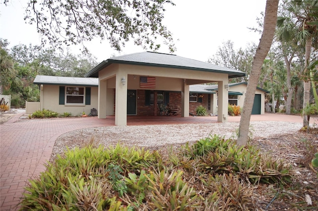 rear view of property featuring a garage