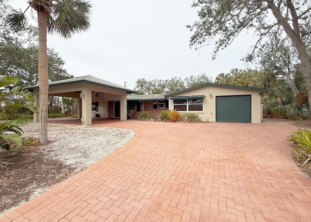 view of front of property featuring a carport and a garage