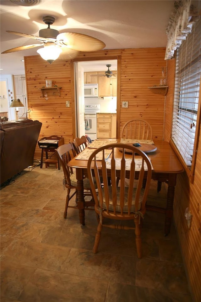 dining area featuring wooden walls