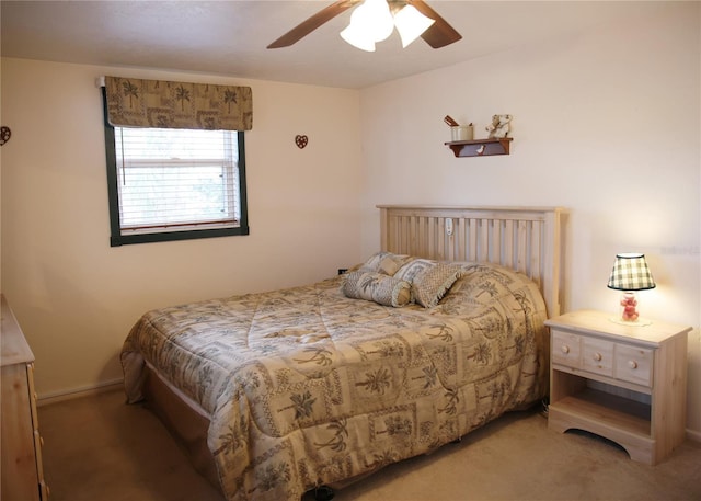 bedroom featuring ceiling fan and dark carpet