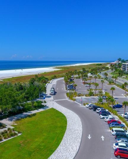 drone / aerial view featuring a water view and a view of the beach