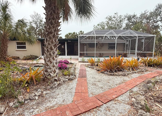 rear view of house featuring a lanai