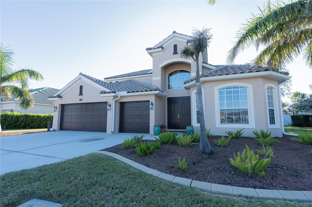 mediterranean / spanish-style home with a garage