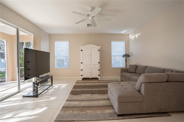 living room with ceiling fan and light tile patterned flooring