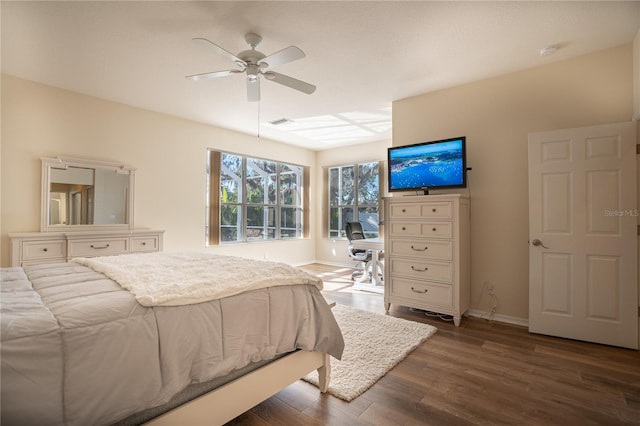 bedroom with dark hardwood / wood-style flooring and ceiling fan