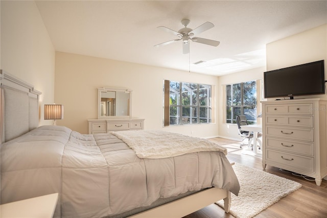 bedroom with light hardwood / wood-style floors and ceiling fan