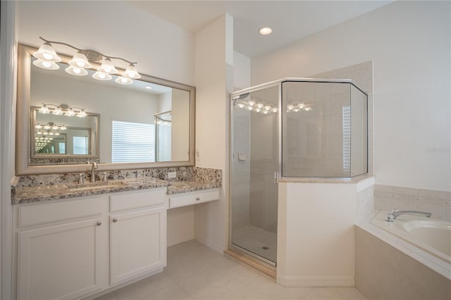 bathroom with tile patterned flooring, vanity, and shower with separate bathtub