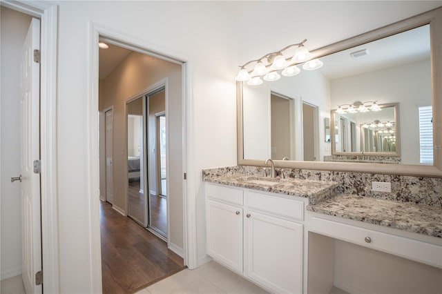 bathroom featuring vanity and wood-type flooring