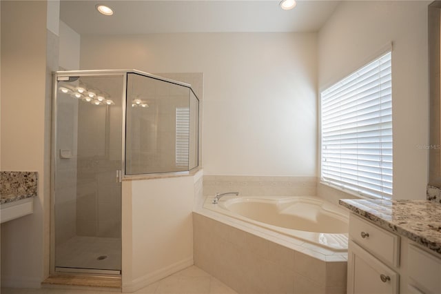 bathroom with plus walk in shower, tile patterned flooring, and vanity