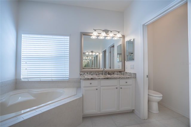 bathroom featuring tile patterned floors, tiled bath, vanity, and toilet