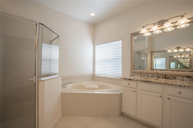 bathroom with tile patterned floors, separate shower and tub, and vanity