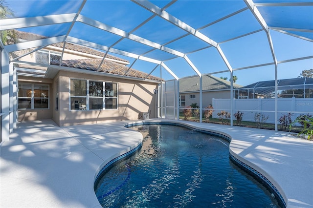 view of swimming pool featuring glass enclosure and a patio area