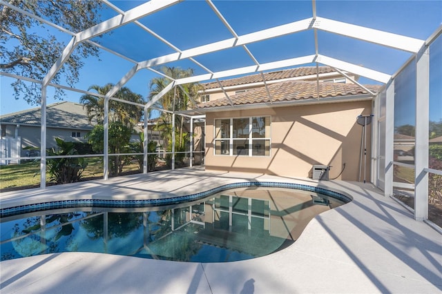 view of pool with a patio area and a lanai