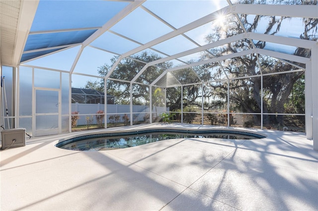 view of pool featuring a patio and glass enclosure