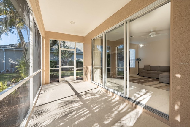 sunroom with plenty of natural light and ceiling fan