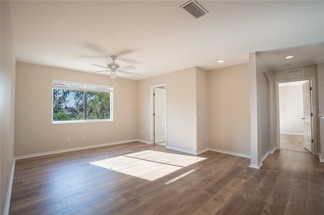 spare room featuring dark hardwood / wood-style floors and ceiling fan