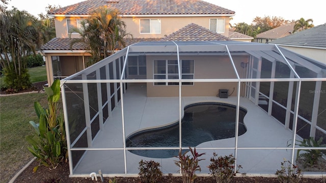 rear view of house featuring a lanai and a patio area