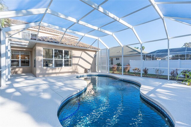 view of pool with a patio area and a lanai