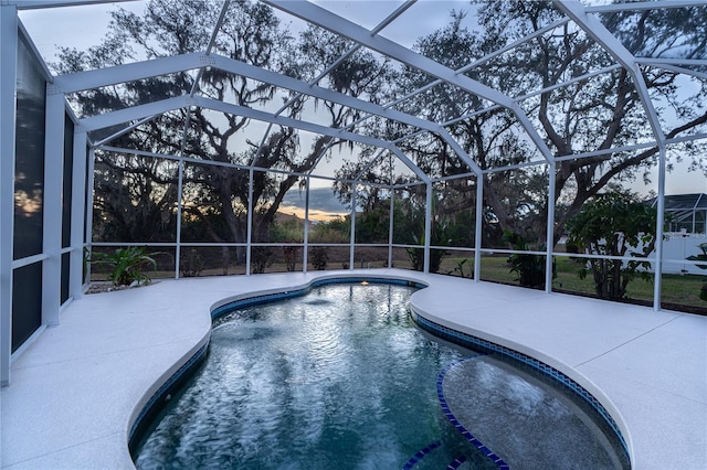 view of pool with a patio area and a lanai