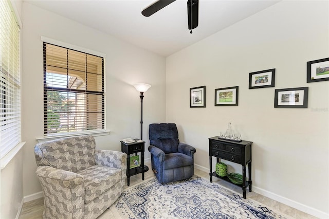 living area with ceiling fan