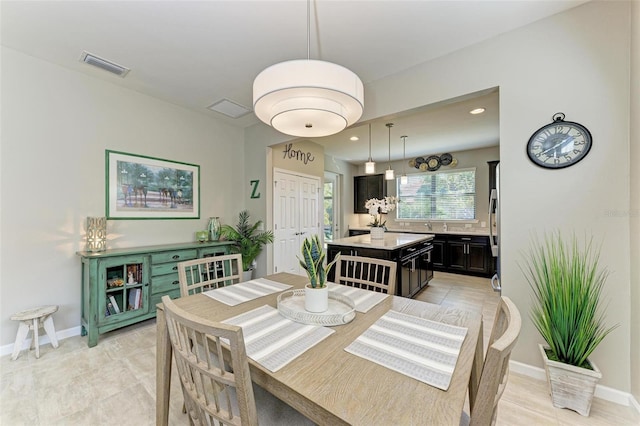 dining area featuring light tile patterned floors