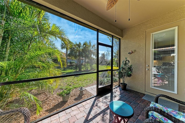 sunroom / solarium featuring ceiling fan