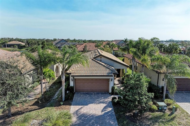 6739 Haverhill Ct, Lakewood Ranch, FL 34202 - view of front of house featuring stucco siding, a residential view, a tiled roof, decorative driveway, and a garage