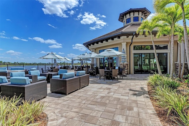 6739 Haverhill Ct, Lakewood Ranch, FL 34202 - view of patio featuring an outdoor living space, a water view, french doors, and outdoor dining space