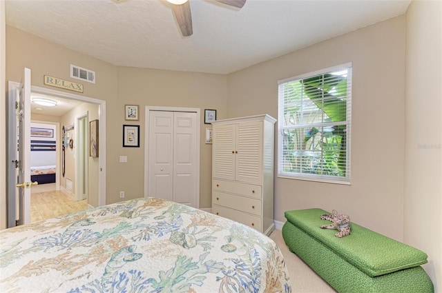 bedroom with ceiling fan and a closet