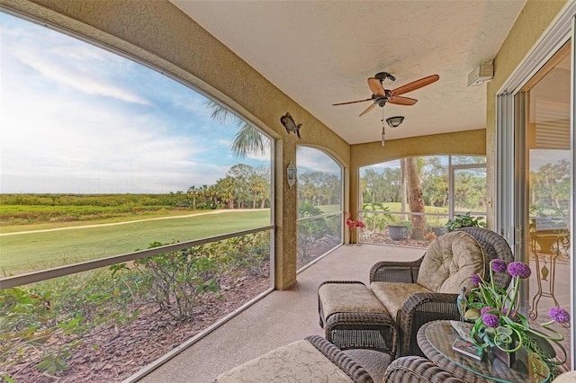 sunroom / solarium featuring ceiling fan