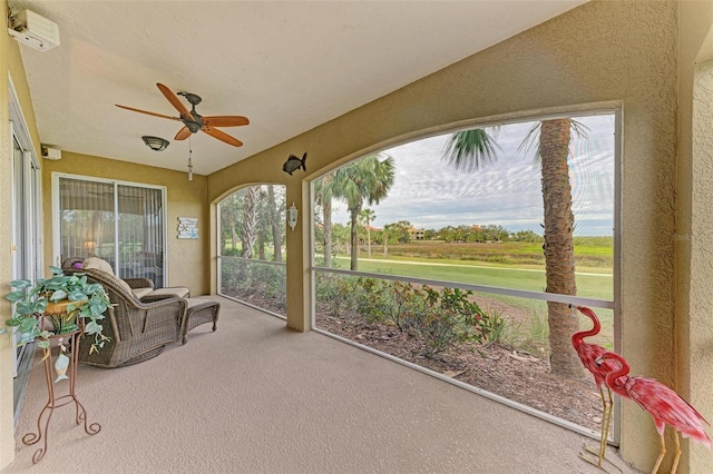 sunroom / solarium featuring ceiling fan