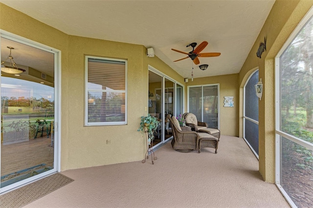 sunroom with ceiling fan