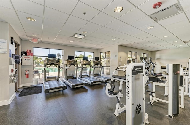 gym with a paneled ceiling