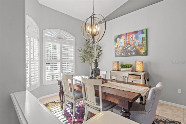 tiled dining space featuring vaulted ceiling and a notable chandelier