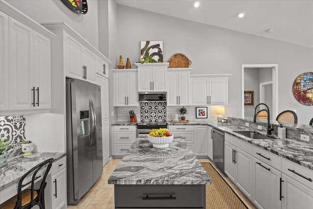 kitchen featuring a center island, stainless steel appliances, white cabinetry, and sink