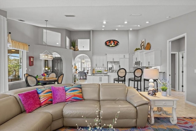 living room featuring a high ceiling and light tile patterned floors