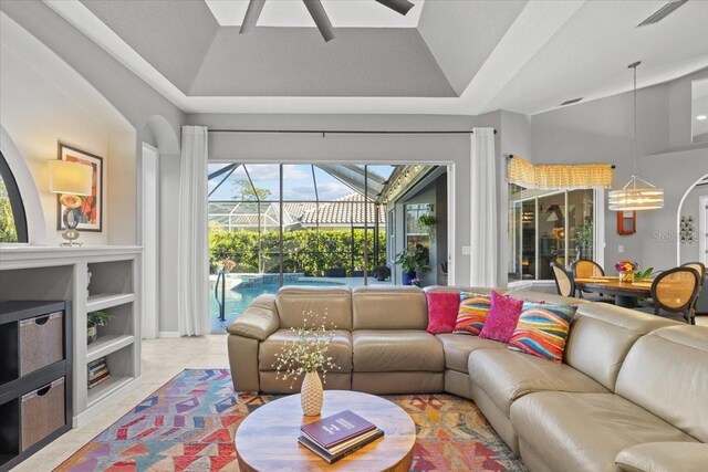 living room with ceiling fan, light tile patterned flooring, and high vaulted ceiling