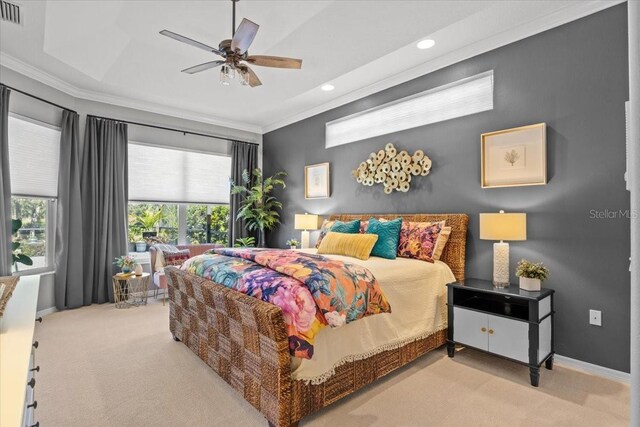 carpeted bedroom with ceiling fan and ornamental molding