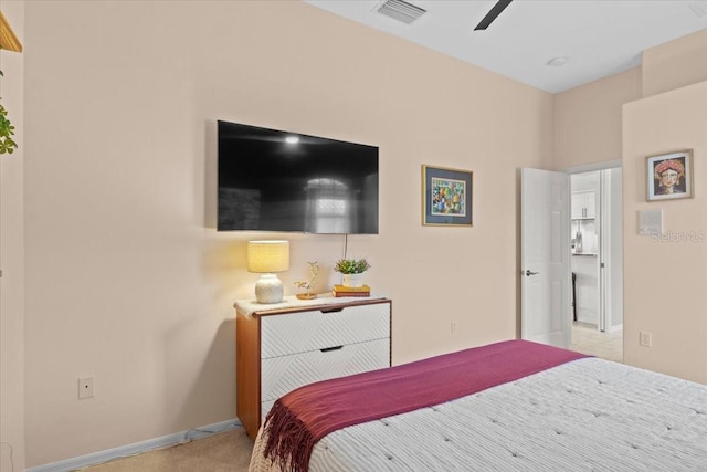 bedroom with ceiling fan and light carpet