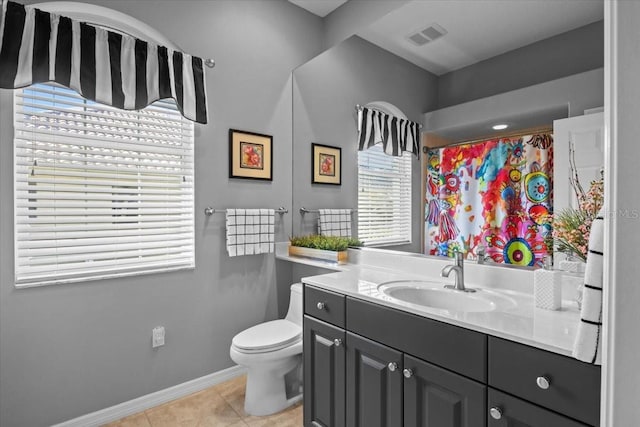 bathroom with a shower with shower curtain, tile patterned floors, vanity, and toilet