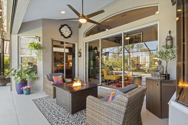 sunroom with ceiling fan and lofted ceiling