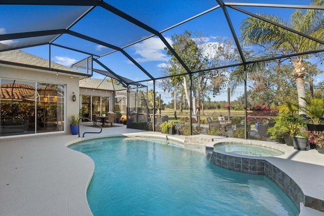 view of pool featuring glass enclosure, a patio area, and an in ground hot tub