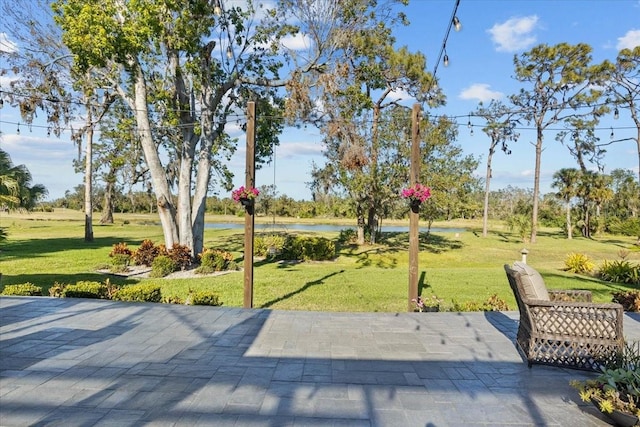 view of property's community with a patio area and a yard